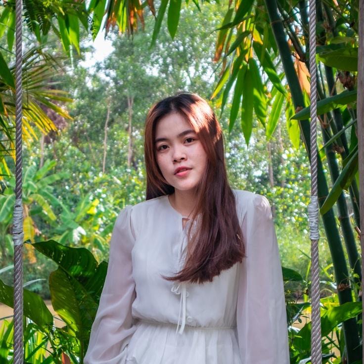 Maya Chen, Lead Design Curator at Plain Anchor Studio, reviewing corporate floral arrangements